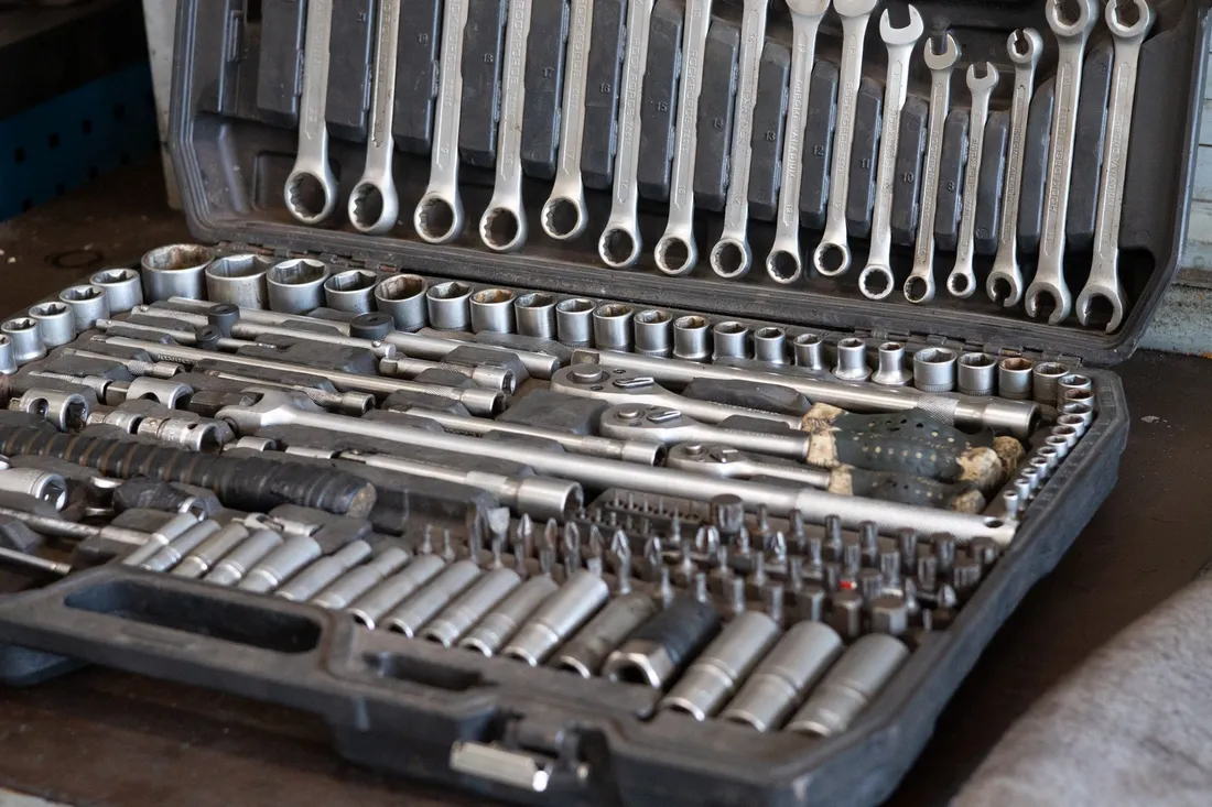 Sockets and wrenches arranged in a portable tool case