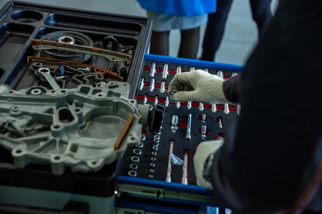 Removed mechanical components and tools arranged for workshop repair
