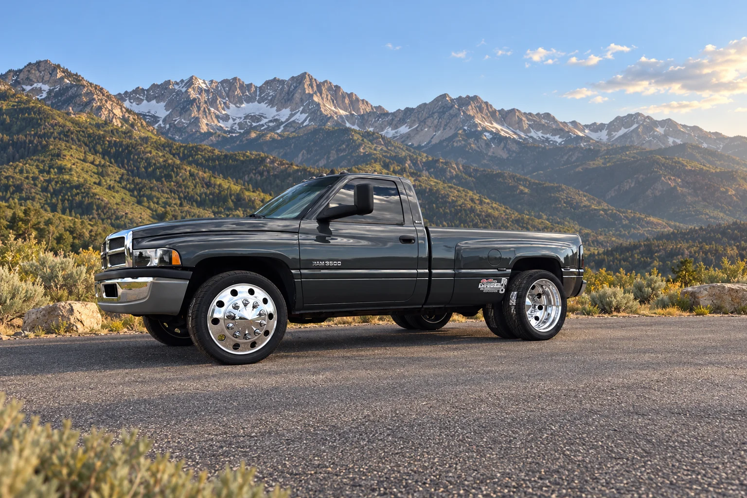 A charcoal Ram dually with a digitally created Utah mountain background